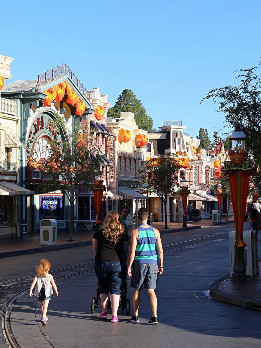 Strollers in Disneyland, walking down Main Street Disneyland