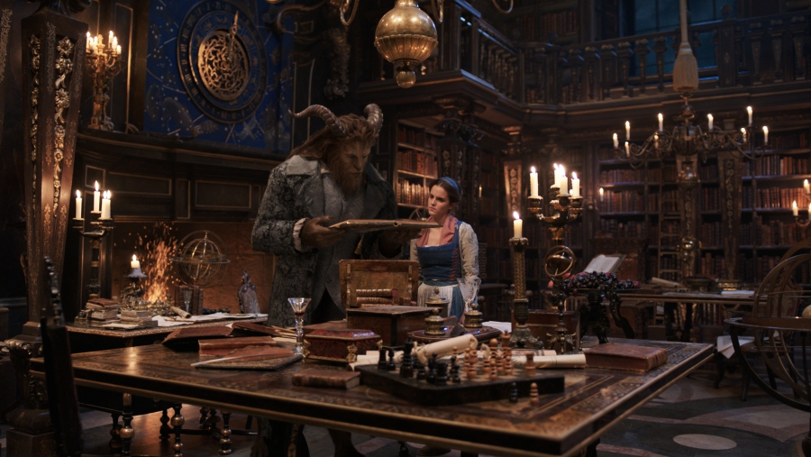 The Beast (Dan Stevens) and Belle (Emma Watson) in the castle library in Disney's BEAUTY AND THE BEAST.