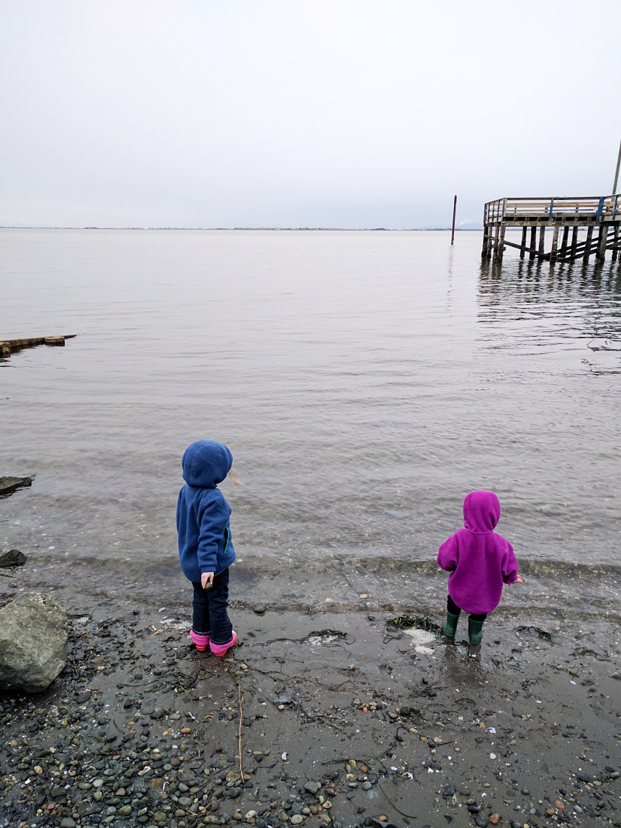 anxiety: pier stretching out to the ocean, children throwing rocks into he ocean
