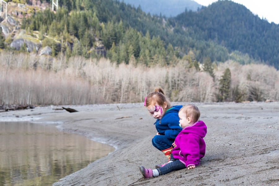 Squamish River Estuary, preschooler and toddler playing on the rivers edge