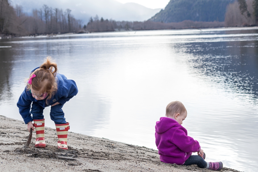 Squamish River Estuary, preschooler and toddler playing on the rivers edge