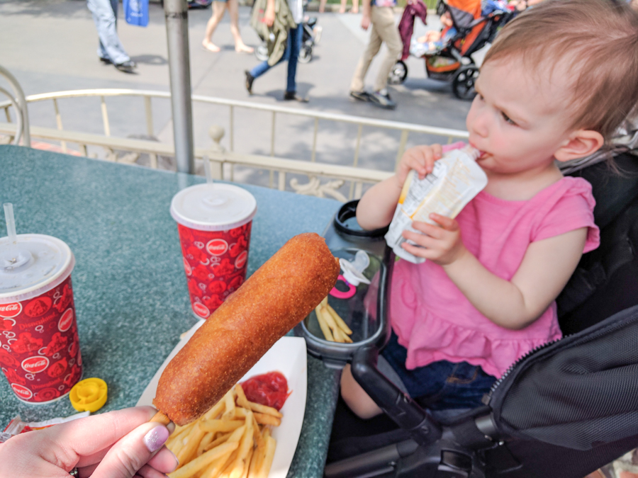 Eating in Disneyland. Corn dog in Disneyland. 