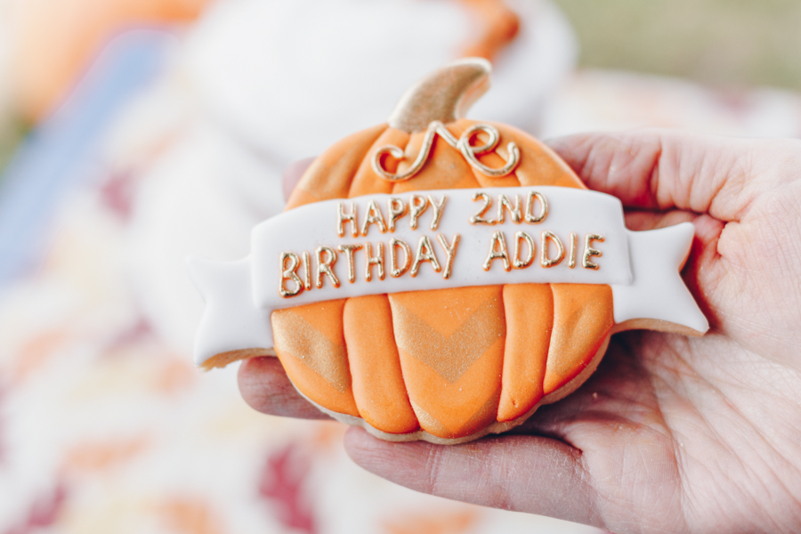 pumpkin patch birthday party, frosted sugar cookie in shape of a pumpkin